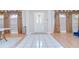Inviting foyer with white tile flooring, hardwood accents, decorative curtains, and a view of the interior at 2117 Laindale Pl, Valrico, FL 33596