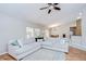 Living room features vaulted ceiling and large sectional couch with view to dining area at 2117 Laindale Pl, Valrico, FL 33596