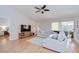 Spacious living room features hardwood floors, fan and large sectional couch at 2117 Laindale Pl, Valrico, FL 33596