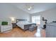 Main bedroom with neutral walls, wood floors, fan and a window with blinds at 2117 Laindale Pl, Valrico, FL 33596