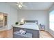 Main bedroom featuring fan, neutral walls, wood floors and ensuite bathroom at 2117 Laindale Pl, Valrico, FL 33596