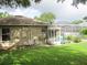 Exterior view of home with a fenced yard, screened-in pool, and well-maintained lawn at 2213 Towering Oaks Cir, Seffner, FL 33584
