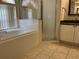 Beautiful bathroom featuring a soaking tub, glass-enclosed shower, and modern vanity at 2213 Towering Oaks Cir, Seffner, FL 33584