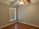 Cozy bedroom featuring a ceiling fan, wood flooring, and natural light at 2213 Towering Oaks Cir, Seffner, FL 33584