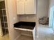 Built-in desk area features black countertop, white cabinetry, and convenient storage space at 2213 Towering Oaks Cir, Seffner, FL 33584