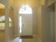 Home foyer featuring tile flooring, arches, and a bright white front door at 2213 Towering Oaks Cir, Seffner, FL 33584