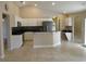 Open kitchen with white cabinets, stainless steel appliances, and black countertops at 2213 Towering Oaks Cir, Seffner, FL 33584