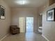 Living room with tiled floors and sliding doors leading to the screened pool area at 2213 Towering Oaks Cir, Seffner, FL 33584