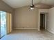 Spacious living room with tile flooring and view of the screened pool area at 2213 Towering Oaks Cir, Seffner, FL 33584