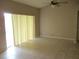 Neutral living room with tiled floor and bright sliding glass door at 2213 Towering Oaks Cir, Seffner, FL 33584