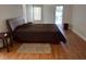 Bedroom with hardwood floors and a view of the screened-in pool area at 2213 Towering Oaks Cir, Seffner, FL 33584