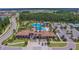 Aerial view of the community pool with water slides, palm trees, and surrounding recreational areas at 29895 Picana Ln, Wesley Chapel, FL 33543