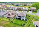Expansive aerial view of a residential community with lush greenery and a tranquil pond at 29895 Picana Ln, Wesley Chapel, FL 33543