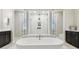 Spa-like bathroom featuring a soaking tub and a large, glass-enclosed shower with dual shower heads at 29895 Picana Ln, Wesley Chapel, FL 33543