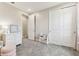 Cozy bedroom features carpeted floors, white trim, and closet with sliding doors at 29895 Picana Ln, Wesley Chapel, FL 33543