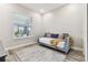 Bedroom with a gray daybed, area rug, and natural light from the window at 29895 Picana Ln, Wesley Chapel, FL 33543