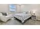 Carpeted bedroom features a modern bed, chair and view from a large window at 29895 Picana Ln, Wesley Chapel, FL 33543