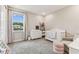 Cozy Bedroom featuring a crib, dresser, and plenty of natural light for a comfortable atmosphere at 29895 Picana Ln, Wesley Chapel, FL 33543