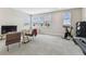 Spacious bonus room featuring carpeted floors and an abundance of natural light from several large windows at 29895 Picana Ln, Wesley Chapel, FL 33543