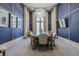 Elegant dining room with blue wallpaper, modern chandelier and neutral furnishings at 29895 Picana Ln, Wesley Chapel, FL 33543