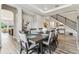 Elegant dining room with modern table, stylish chairs, and access to living spaces at 29895 Picana Ln, Wesley Chapel, FL 33543