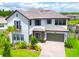 Stunning two-story home featuring a tile roof, brick driveway, and an attached two-car garage at 29895 Picana Ln, Wesley Chapel, FL 33543