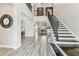 Grand foyer with soaring ceilings, stylish staircase, and elegant wood-look tile flooring at 29895 Picana Ln, Wesley Chapel, FL 33543