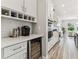 Elegant kitchen featuring built-in wine storage and stainless steel appliances at 29895 Picana Ln, Wesley Chapel, FL 33543