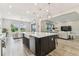Bright kitchen with stainless steel appliances and a view into the cozy living room at 29895 Picana Ln, Wesley Chapel, FL 33543