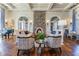 A cozy lounge area with hardwood floors, comfortable seating, and a stone fireplace at 29895 Picana Ln, Wesley Chapel, FL 33543