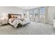Spacious primary bedroom featuring large windows and elegant decor at 29895 Picana Ln, Wesley Chapel, FL 33543