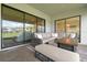 Relaxing outdoor patio with comfortable seating, a fire table, and a scenic view at 29895 Picana Ln, Wesley Chapel, FL 33543