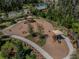 Aerial view of a playground with sunshades, bordered by trees and paths at 29895 Picana Ln, Wesley Chapel, FL 33543