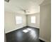 Bright bedroom with hardwood floors, white trim, and dual windows providing natural light at 3412 N 54Th St, Tampa, FL 33619