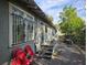Side exterior of a house featuring a concrete walkway, bars on the windows, and light gray paint at 3503 N 11Th St, Tampa, FL 33605