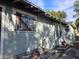 Exterior view showcasing the side of the home, the bars on the windows, and some damage at 3503 N 11Th St, Tampa, FL 33605