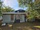 Exterior view of home with a weathered front door, bars on the windows, and a small front yard at 3503 N 11Th St, Tampa, FL 33605