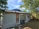 Exterior view of home with a weathered front door, bars on the windows, and a small front yard at 3503 N 11Th St, Tampa, FL 33605