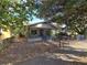 Quaint bungalow with inviting front porch, framed by mature trees, enclosed with a metal chain-link fence at 3503 N 11Th St, Tampa, FL 33605