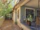 Vintage home featuring a covered porch, brick accents, and bordered by a chain link fence at 3503 N 11Th St, Tampa, FL 33605