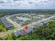 An aerial view shows the home's location within a neighborhood with a community lake at 3603 Woodmont Dr, Parrish, FL 34219