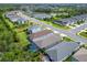 Aerial view of a lovely residential neighborhood with lush landscaping and a community lake at 3603 Woodmont Dr, Parrish, FL 34219