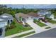 Charming single-Gathering home featuring a well-manicured lawn, landscaped garden beds, and a two-car garage at 3603 Woodmont Dr, Parrish, FL 34219