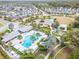 Aerial view of the community clubhouse, pool, playground, and lush landscaping at 3603 Woodmont Dr, Parrish, FL 34219