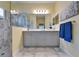 Bathroom with dual sink vanity, framed mirror, and walk-in shower at 3603 Woodmont Dr, Parrish, FL 34219