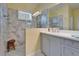 Bright bathroom features a double vanity with modern fixtures and a large shower at 3603 Woodmont Dr, Parrish, FL 34219