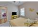 Comfortable bedroom with bright yellow accents and a window with white shutters at 3603 Woodmont Dr, Parrish, FL 34219