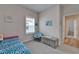 Cozy bedroom with ample natural light, featuring a bed, wood floors, and stylish decor at 3603 Woodmont Dr, Parrish, FL 34219