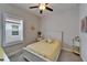 Sunny bedroom boasts a cozy bed, window with shutters, and bright butterfly decor at 3603 Woodmont Dr, Parrish, FL 34219