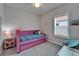 Bright bedroom with a pink daybed, stylish decor and a cheerful ambiance, perfect for relaxation at 3603 Woodmont Dr, Parrish, FL 34219